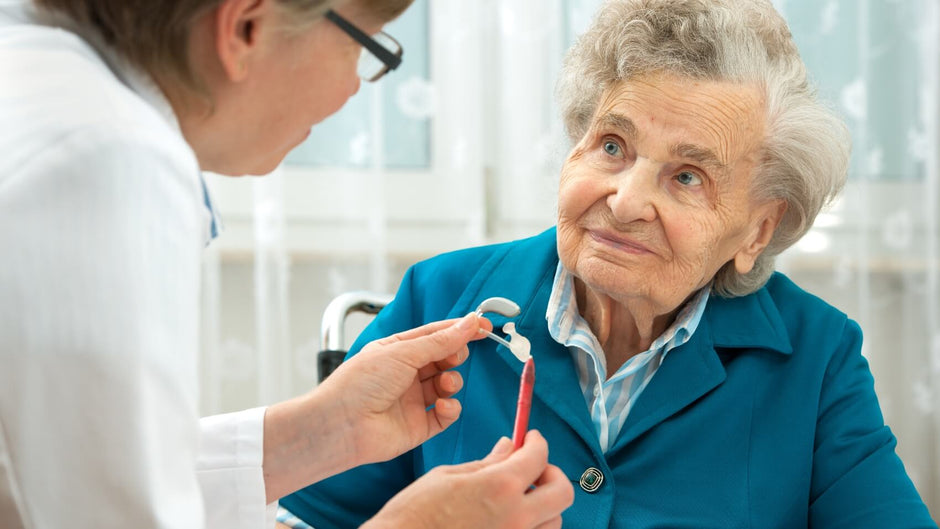 Audiologist advising a hearing aid customer.