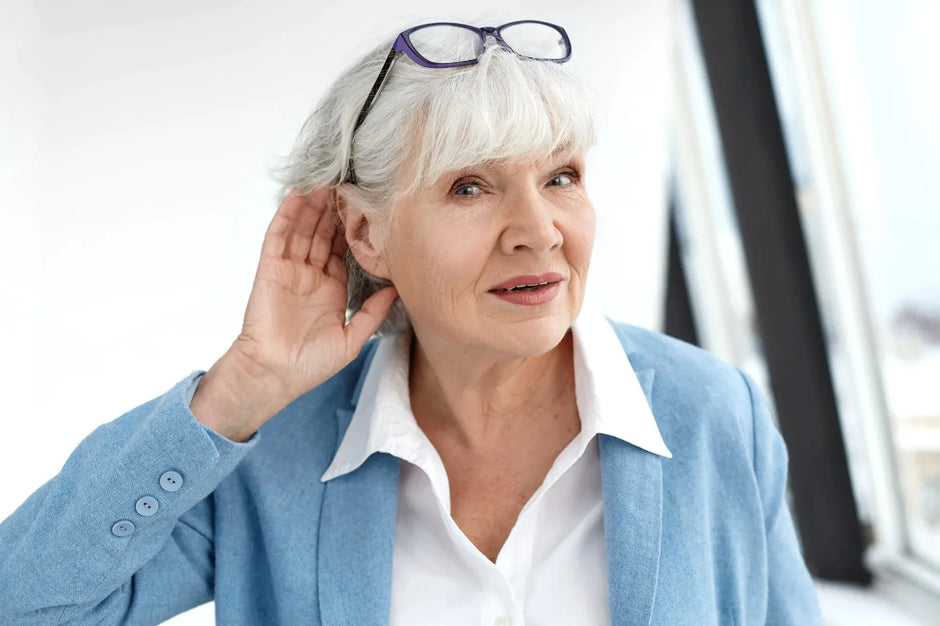 Women with tinnitus holding her ear