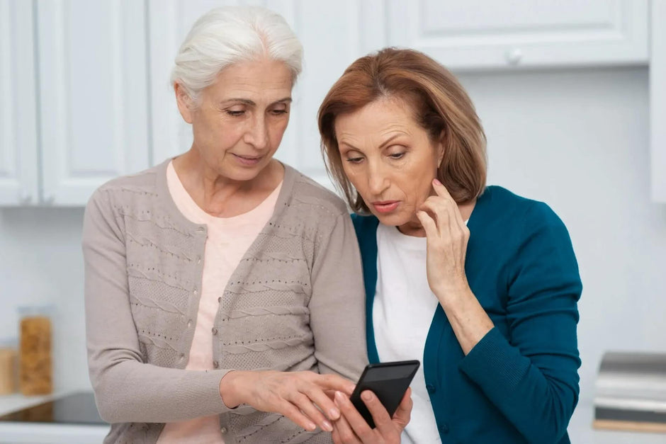 age related hearing loss- 2 women checking phone